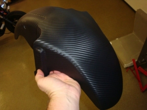 Front fender being wrapped in 3M carbon fiber DI-NOC